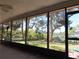 Enclosed lanai with views of lush backyard landscaping and dock at 4328 Marine Pkwy, New Port Richey, FL 34652