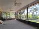 Spacious enclosed lanai with tile flooring and views of the lush backyard at 4328 Marine Pkwy, New Port Richey, FL 34652