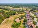 Expansive aerial view of a home located on a golf course with lush greenery and mature trees in the background at 4423 Gevalia Dr, Brooksville, FL 34604