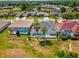 Aerial view of several homes, with swimming pools and screened in patios, in a neighborhood with well-maintained lawns at 4423 Gevalia Dr, Brooksville, FL 34604