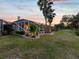 Lush backyard with tropical landscaping and screened lanai creating a private outdoor oasis at 4423 Gevalia Dr, Brooksville, FL 34604