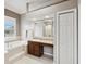 Bright bathroom features a large tub, vanity and window with natural light at 4423 Gevalia Dr, Brooksville, FL 34604