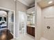 Bright bathroom featuring a walk in shower, vanity, toilet and doorway leading to bedroom at 4423 Gevalia Dr, Brooksville, FL 34604