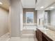 Bright bathroom featuring a large tub, walk in shower, vanity and window with natural light at 4423 Gevalia Dr, Brooksville, FL 34604