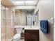 Well-lit bathroom with a walk-in shower, neutral color scheme, and storage at 4423 Gevalia Dr, Brooksville, FL 34604