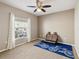Bedroom with carpet, ceiling fan, natural light from a window, and bicycle-themed decor at 4423 Gevalia Dr, Brooksville, FL 34604
