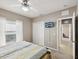 Neutral bedroom features a ceiling fan, carpeted floors, and a window with sheer curtains at 4423 Gevalia Dr, Brooksville, FL 34604