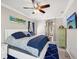 Bright bedroom features a large bed, and a window with dark drapes at 4423 Gevalia Dr, Brooksville, FL 34604
