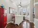 Charming breakfast nook with bay windows, custom table and chairs, and a unique vintage-style refrigerator at 4423 Gevalia Dr, Brooksville, FL 34604