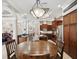 Open dining area with a circular table, seamlessly connecting to the kitchen with stainless steel appliances at 4423 Gevalia Dr, Brooksville, FL 34604