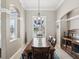 Charming dining room showcasing a large window for natural light and a decorative chandelier at 4423 Gevalia Dr, Brooksville, FL 34604