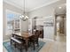 Formal dining room featuring a classic chandelier, traditional furniture, and a large window for natural light at 4423 Gevalia Dr, Brooksville, FL 34604