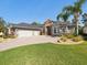 This single Gathering home boasts a beautiful lawn, mature landscaping, and a three car garage at 4423 Gevalia Dr, Brooksville, FL 34604