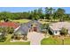 Well maintained single Gathering home boasts manicured lawn, mature landscaping, and golf course views at 4423 Gevalia Dr, Brooksville, FL 34604