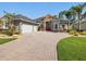 This single Gathering home boasts a beautiful lawn, mature landscaping, and a three car garage at 4423 Gevalia Dr, Brooksville, FL 34604