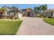 This single Gathering home boasts a beautiful lawn, mature landscaping, and a three car garage at 4423 Gevalia Dr, Brooksville, FL 34604