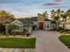 This single Gathering home boasts a beautiful lawn, mature landscaping, and an inviting brick-paved driveway at 4423 Gevalia Dr, Brooksville, FL 34604