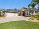 Well-manicured front yard, stone accents, and charming red door at 4423 Gevalia Dr, Brooksville, FL 34604