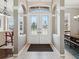 Elegant foyer with leaded glass doors, columns, and tile flooring at 4423 Gevalia Dr, Brooksville, FL 34604