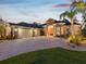 Elegant home with meticulous landscaping, showcasing a paver driveway and a grand entrance at 4423 Gevalia Dr, Brooksville, FL 34604