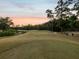 Picturesque golf course view with lush green fairways and mature trees at sunset at 4423 Gevalia Dr, Brooksville, FL 34604