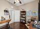 Home office featuring hardwood floors, world map, and a comfortable seating area at 4423 Gevalia Dr, Brooksville, FL 34604