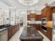 Spacious kitchen with center island, stainless appliances, and custom wood cabinetry at 4423 Gevalia Dr, Brooksville, FL 34604