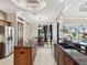 Open concept kitchen with granite countertops, stainless appliances, breakfast area, and backyard views at 4423 Gevalia Dr, Brooksville, FL 34604