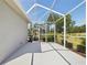 Spacious, screened-in lanai with views of the lush landscaping and golf course at 4423 Gevalia Dr, Brooksville, FL 34604