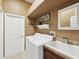 Functional laundry room with a washer, dryer, utility sink, and storage space at 4423 Gevalia Dr, Brooksville, FL 34604