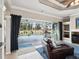 Inviting living room with leather seating, pool view, and sliding glass doors to the outdoor patio and pool area at 4423 Gevalia Dr, Brooksville, FL 34604
