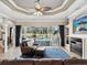 Cozy living room with a fireplace and views of the sparkling pool through sliding glass doors at 4423 Gevalia Dr, Brooksville, FL 34604