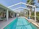 Outdoor living with pool and lanai surrounded by landscaping, enclosure, and blue sky at 4423 Gevalia Dr, Brooksville, FL 34604