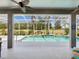 Enclosed pool and patio area with ceiling fans, columns, and golf course view at 4423 Gevalia Dr, Brooksville, FL 34604