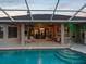A view of the pool with easy-access steps and nearby covered patio at 4423 Gevalia Dr, Brooksville, FL 34604