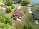 Aerial view showing a home's beautiful lawn and brick driveway at 4469 Lake In The Woods Dr, Spring Hill, FL 34607