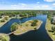 Breathtaking aerial view showcases a tranquil pond with lush greenery and surrounding homes, offering a serene neighborhood setting at 4469 Lake In The Woods Dr, Spring Hill, FL 34607