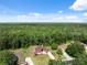 Gorgeous residential home with brick driveway and lush green surroundings nestled among dense green forest at 4469 Lake In The Woods Dr, Spring Hill, FL 34607