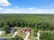 Overhead shot of a gorgeous house with a brick drive and mature trees and greenery at 4469 Lake In The Woods Dr, Spring Hill, FL 34607