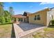 Exterior home view with large brick patio and screened in porch in backyard at 4469 Lake In The Woods Dr, Spring Hill, FL 34607