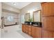 Bathroom with double sink vanity, tub and decorative window at 4469 Lake In The Woods Dr, Spring Hill, FL 34607