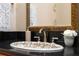 Close up of the vanity in the bathroom with a granite countertop and ornate sink at 4469 Lake In The Woods Dr, Spring Hill, FL 34607