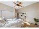 Bright bedroom with white bedding, ceiling fan, and a large closet for ample storage at 4469 Lake In The Woods Dr, Spring Hill, FL 34607
