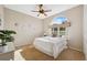 Cozy bedroom featuring a large window, ceiling fan, and comfortable bed at 4469 Lake In The Woods Dr, Spring Hill, FL 34607