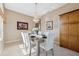 Bright dining room featuring a modern chandelier, tile floors, and custom storage at 4469 Lake In The Woods Dr, Spring Hill, FL 34607