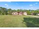 Charming single-Gathering home with brick accents, a well-manicured lawn and landscaping at 4469 Lake In The Woods Dr, Spring Hill, FL 34607