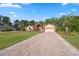 Charming single-Gathering home with brick accents, two-car garage and a large brick driveway at 4469 Lake In The Woods Dr, Spring Hill, FL 34607