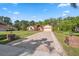 A spacious single-story home with a brick driveway and lush landscaping in a serene setting at 4469 Lake In The Woods Dr, Spring Hill, FL 34607