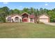 Charming single-Gathering home with brick accents, well-manicured lawn and landscaping at 4469 Lake In The Woods Dr, Spring Hill, FL 34607