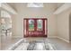 Grand foyer featuring a striking tile inlay, a beautiful double-door entry, and high ceilings at 4469 Lake In The Woods Dr, Spring Hill, FL 34607